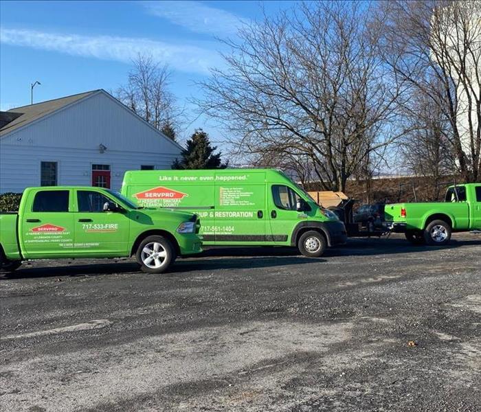 Three SERVPRO vehicles parked in front of a church
